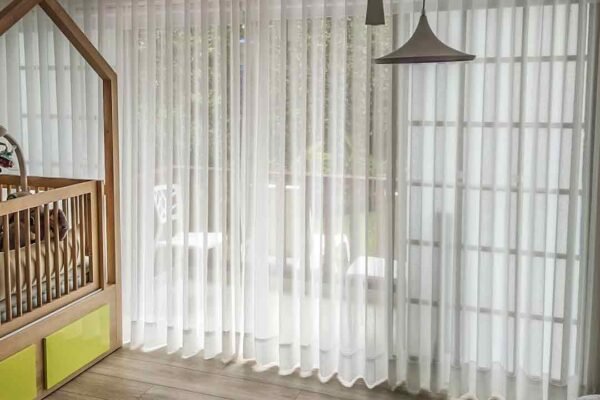 Cortina onda serena en tela translúcida blanca, creando suaves pliegues ondulados que aportan elegancia y luminosidad a la habitación