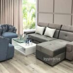 Sofacama modular en forma de L tapizado en tela gris, ideal para espacios modernos y versátiles